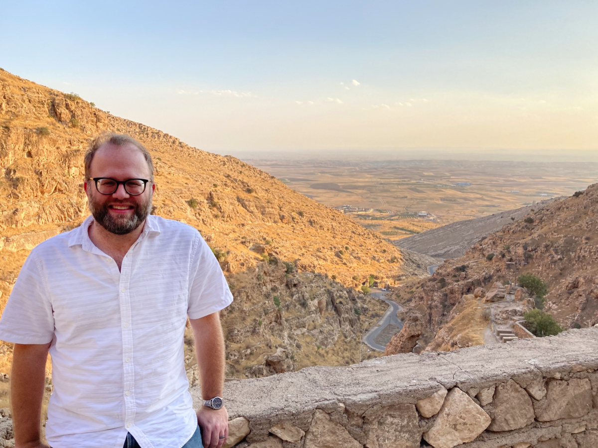 Shane Liesegang poses at the Rabban Hormizd Monastery in Alqosh, Iraq, overlooking the Nineveh Plains.