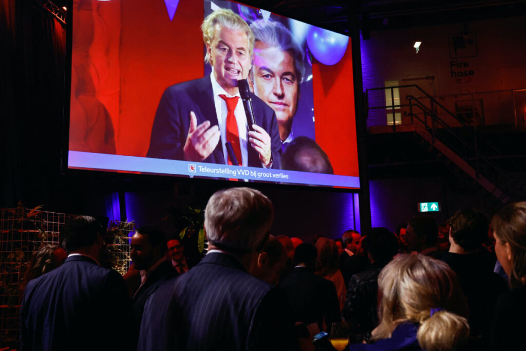 Dutch far-right politician and leader of the PVV party Geert Wilders appears on a screen as supporters of Dilan Yesilgoz, the leader of VVD, gather for exit poll and early results in the Dutch parliamentary elections, in The Hague, Netherlands, on 22nd November, 2023.