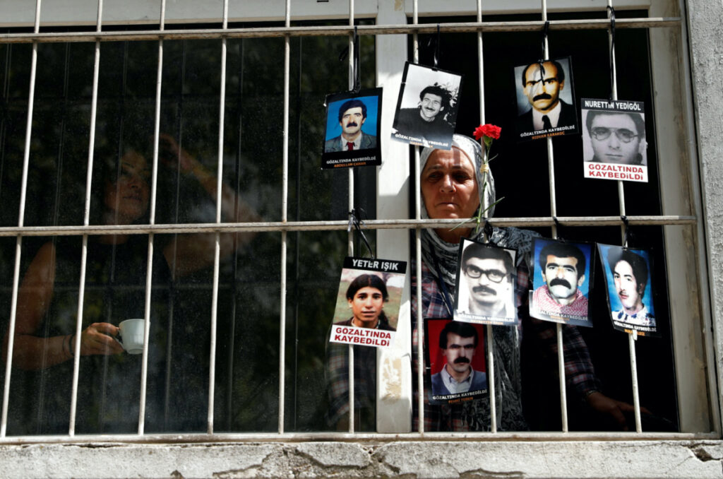 A member of the Saturday Mothers looks out of the window of Human Rights Association after they were prevented by the security forces to march to Galatasaray Square, where they hold a vigil every week, sitting in silence and holding pictures of relatives who went missing in police detention, in Istanbul, Turkey on 8th September, 2018