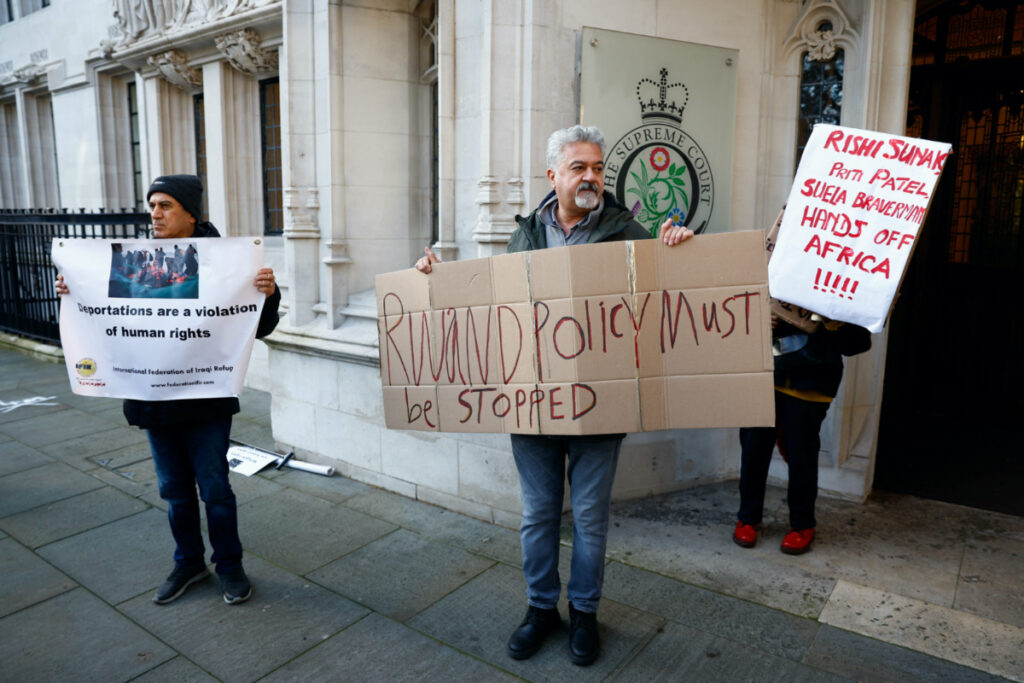 Protestors hold placards outside of the Supreme Court, on the day the Supreme Court delivers its ruling on whether the government can go ahead with its plan to deport migrants to Rwanda, in London, Britain, on 15th November, 2023.