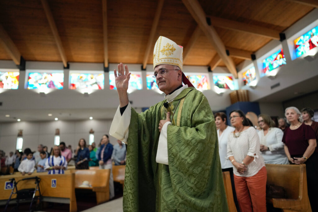 Rev Silvio Baez, auxiliary bishop of Managua, Nicaragua, waves to parishioners as he enters to perform Mass at St Agatha Catholic Church, which has become the spiritual home of the growing Nicaraguan diaspora, on Sunday, 5th November, 2023, in Miami.