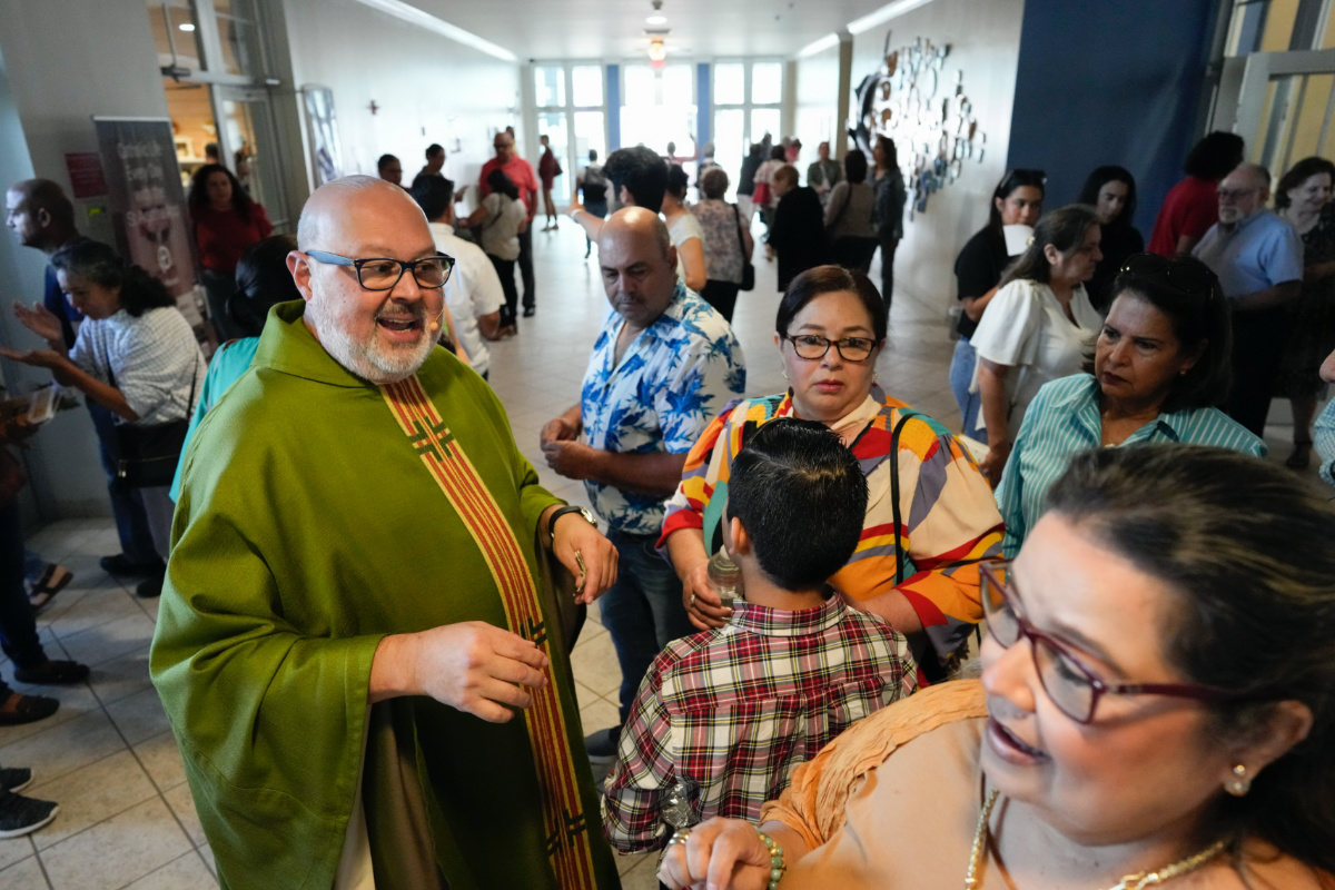 Rev Marcos Somarriba talks with parishioners following Mass at St Agatha Catholic Church, which has become the spiritual home of the growing Nicaraguan diaspora, on Sunday, 5th November, 2023, in Miami.