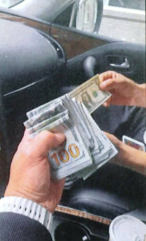 An undercover US law enforcement officer is handed $US15,000, described by the US. Department of Justice as the advance cash payment, by an associate of Nikhil Gupta, who was charged with orchestrating the attempted murder of a Sikh separtist, in a car in the Manhattan borough of New York City, US, on 9th June, 2023, in a photograph contained in an indictment.