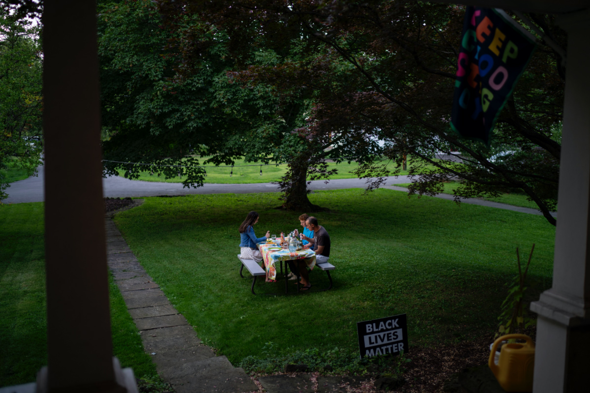 Rev Stephen Cady, right, has dinner with this children, Ellie, 16, left, and Charlie, 14, outside their home in Rochester, New York, on Monday, 21st August, 2023.