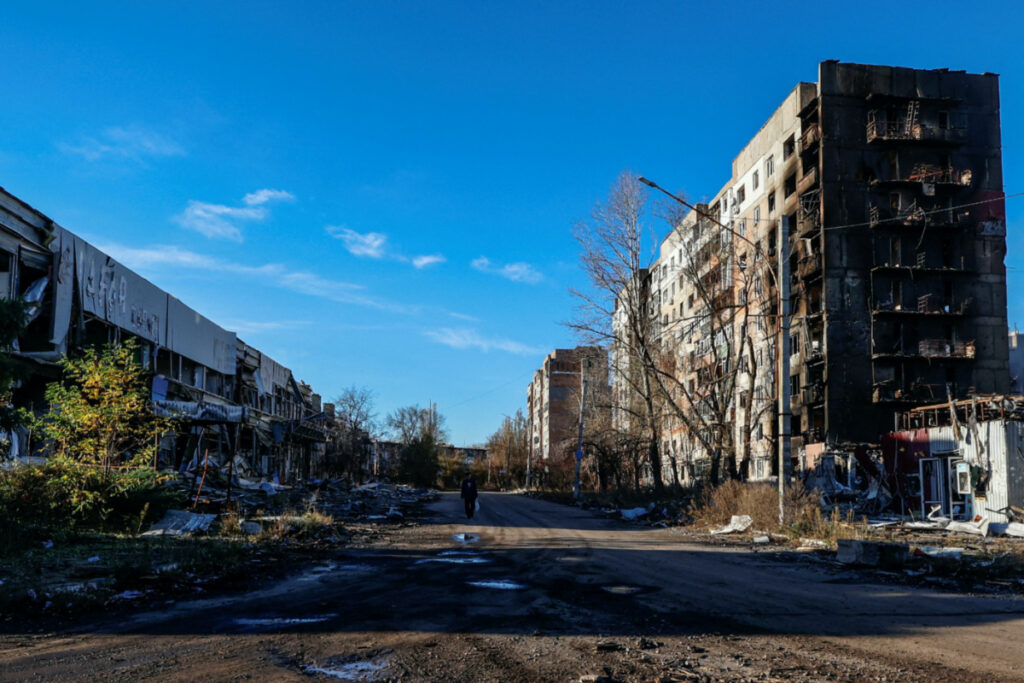 A local resident walks next to residential buildings heavily damaged by Russian military strikes in the front line town of Avdiivka, amid Russia's attack on Ukraine, in Donetsk region, Ukraine, on 8th November, 2023.