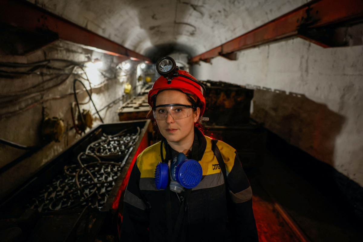 Krystyna, 22-years-old, stands next to a mine train battery at her workplace at an underground mine, amid Russia's attack on Ukraine, in Dnipropetrovsk region, Ukraine, on 17th November, 2023.