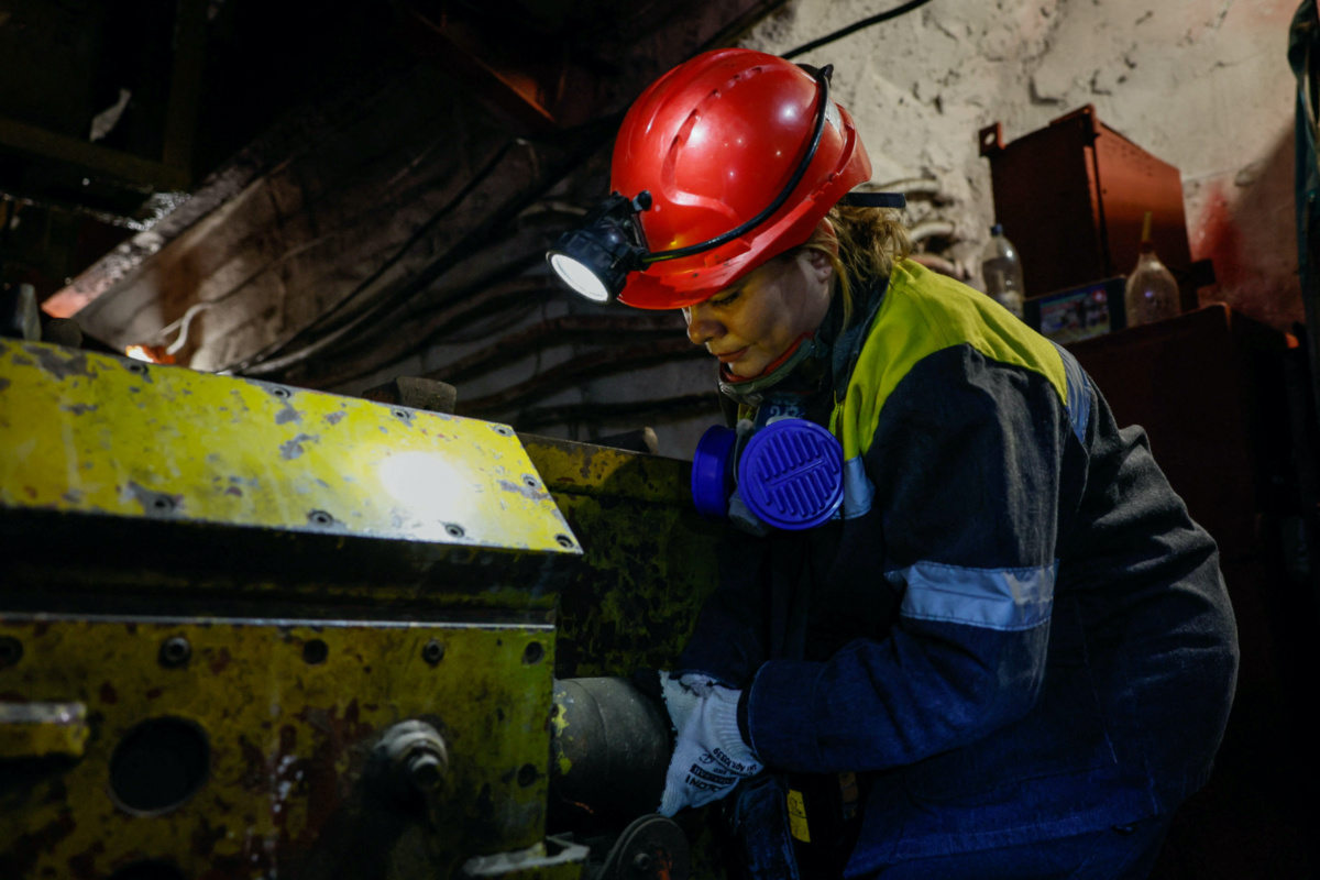 Nataliia, 43-years-old, connects power to a mine train battery charger, in her workplace at an underground mine, amid Russia's attack on Ukraine, in Dnipropetrovsk region, Ukraine on 17th November, 2023.