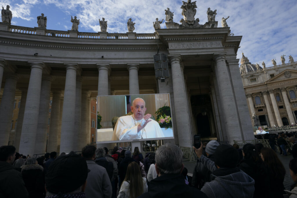 Pope Francis appears on a giant monitor set up in St. Peter's Square at The Vatican, on Sunday, 26th November, 2023, as he blesses the faithful gathered in the square for the traditional Angelus noon prayer.