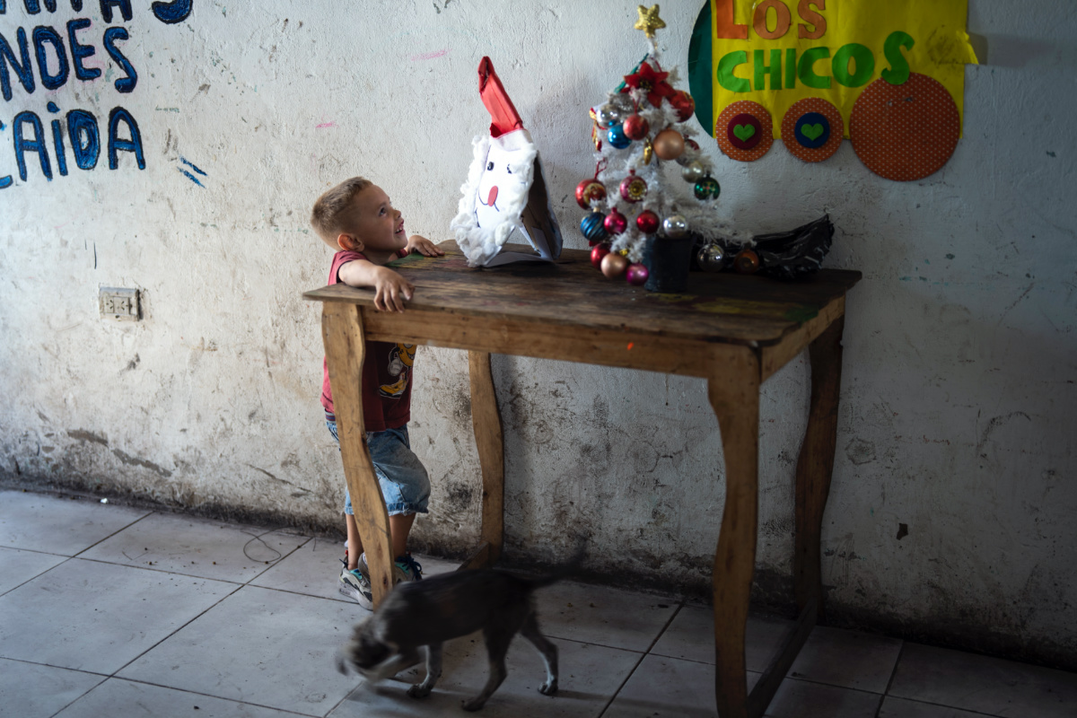 A child looks at a Santa craft at a pre-Christmas celebration organized by "Los Chicos de la Via" soup kitchen, in Buenos Aires, Argentina, Saturday, 23rd December, 2023