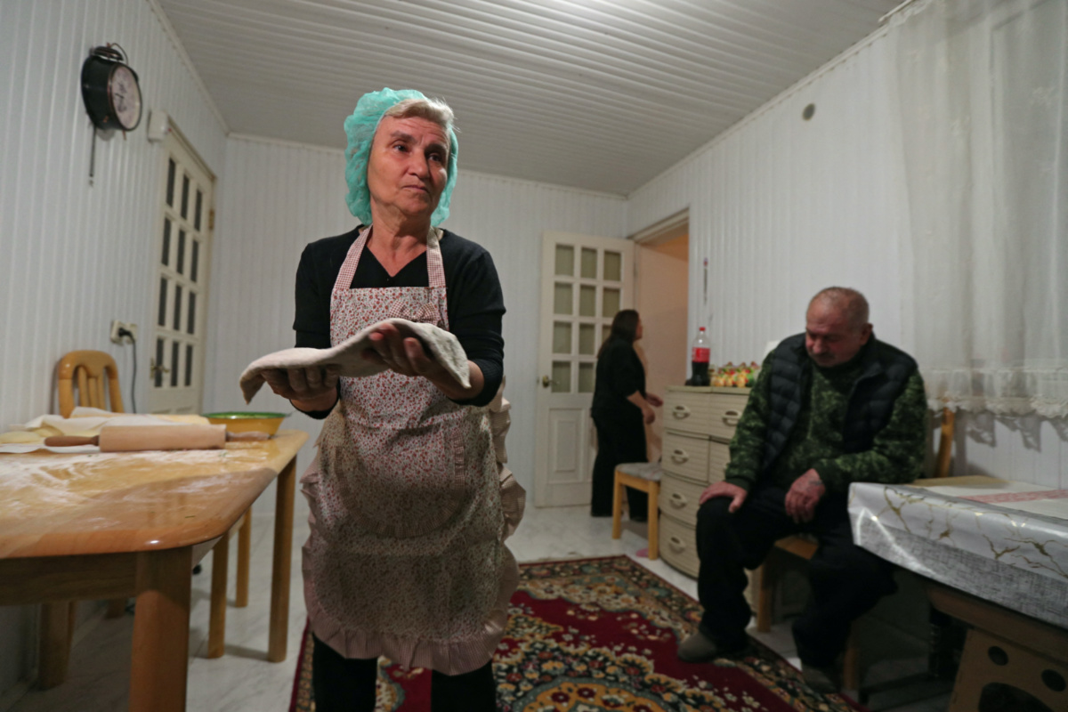 Alvina Gasparyan, 65, a refugee from Nagorno-Karabakh region, makes traditional Zhingyalov hats flatbread to sell and earn money for her family, in the city of Vanadzor, Armenia, on 21st November, 2023