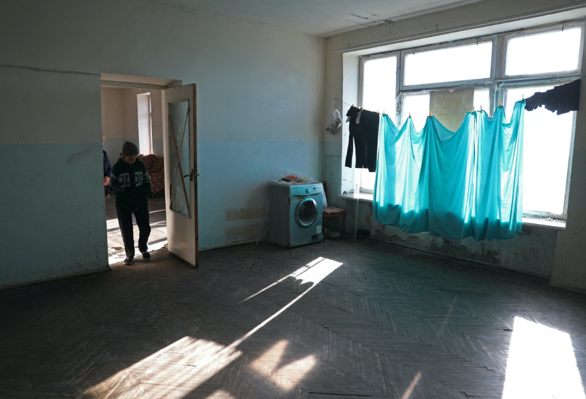 Refugees from Nagorno-Karabakh region walk through the disused library where they temporarily live in the town of Masis, Armenia, on 22nd November, 2023.
