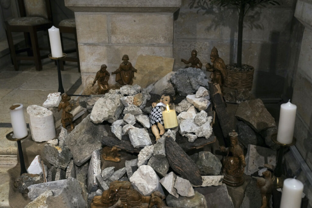 An installation of a scene of the Nativity of Christ with a figure symbolizing baby Jesus lying amid the rubble, in reference to Gaza, inside the Evangelical Lutheran Church in the West Bank town of Bethlehem, on Sunday, 10th December, 2023.