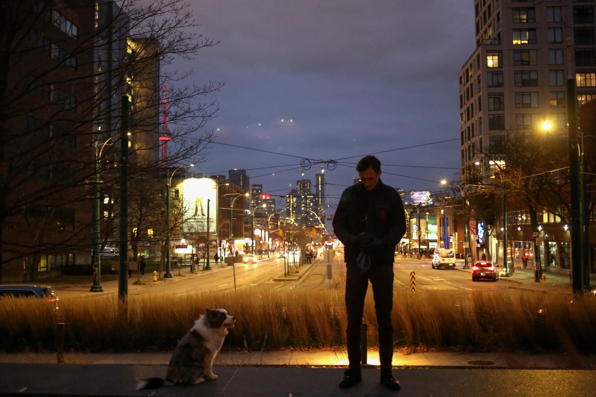 Justinas Stankus, 38, who came to Canada from Lithuania in 2019 and is studying at the University of Toronto, walks his dog in Toronto, Ontario, Canada, on 29th November, 2023