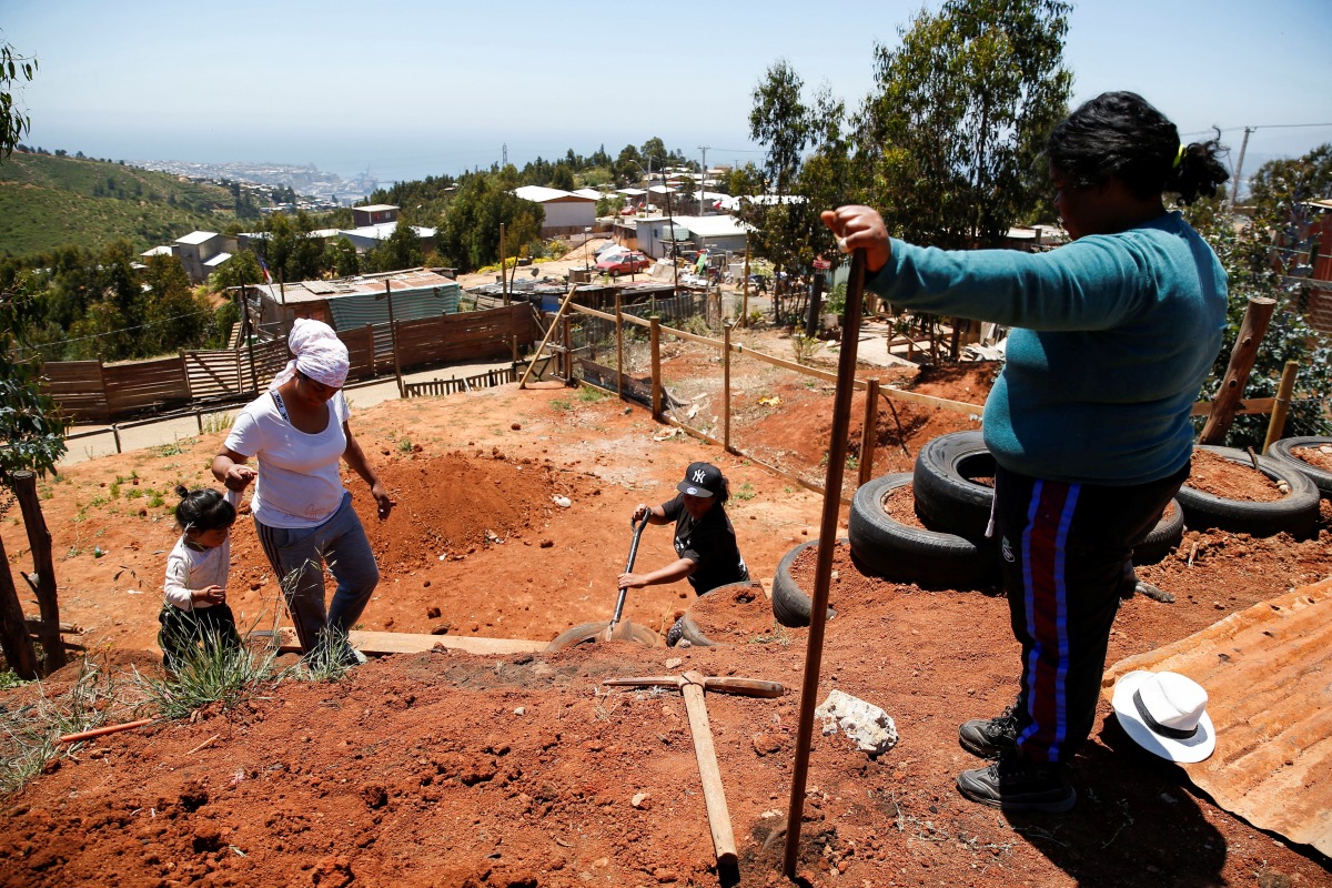 Venezuelan immigrants work on building their house in an informal settlement, in Valparaiso, Chile on 6th December, 2023