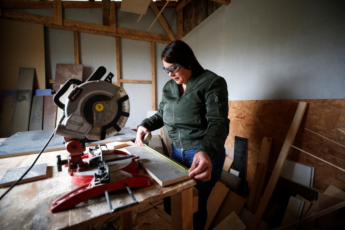 Venezuelan immigrant Yajaira Salazar works in her carpentry shop in an informal settlement, in Valparaiso, Chile on 30th November, 2023.