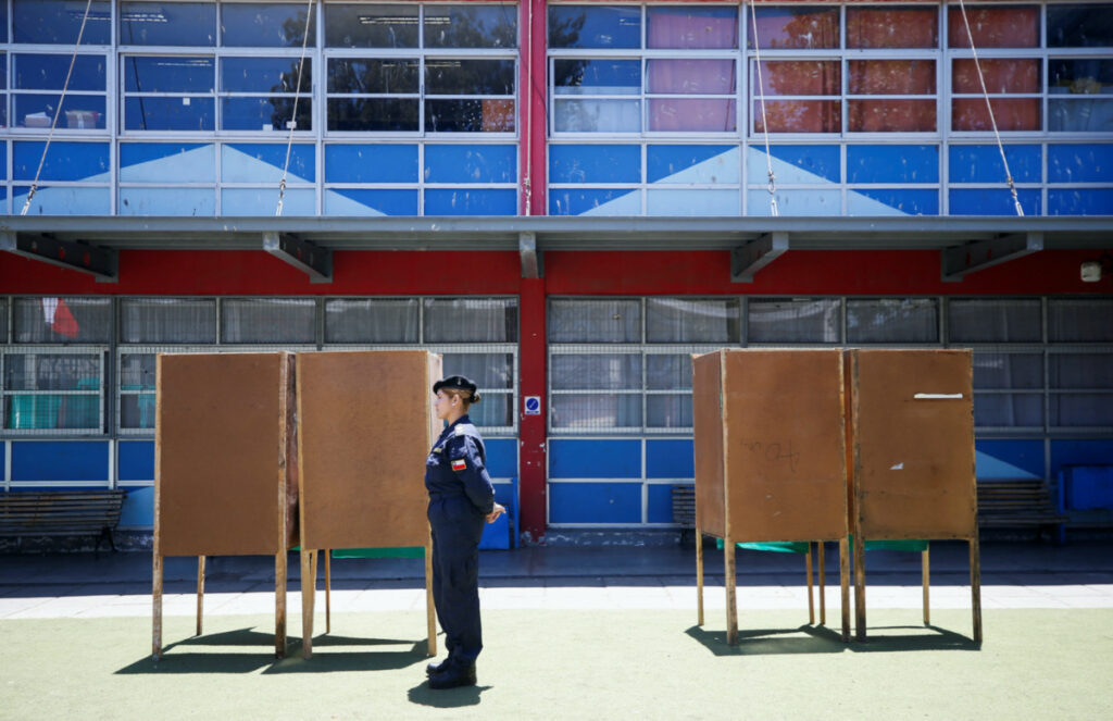 A Chilean Navy officer stands guard next to voting booths before the constitutional referendum which will be held on 17th December, in Valparaiso, Chile, on 15th December, 2023