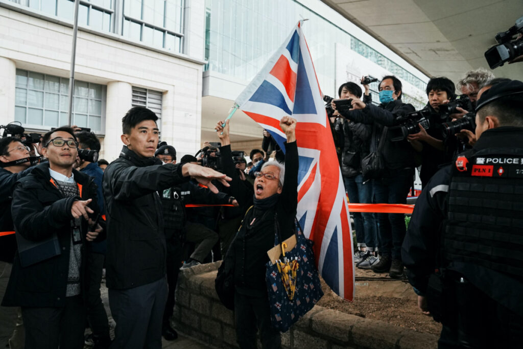 A supporter waves the Union Jack flag outside the West Kowloon Magistrates' Courts during the national security trial of media mogul Jimmy Lai, founder of Apple Daily, in Hong Kong, China on 18th December, 2023