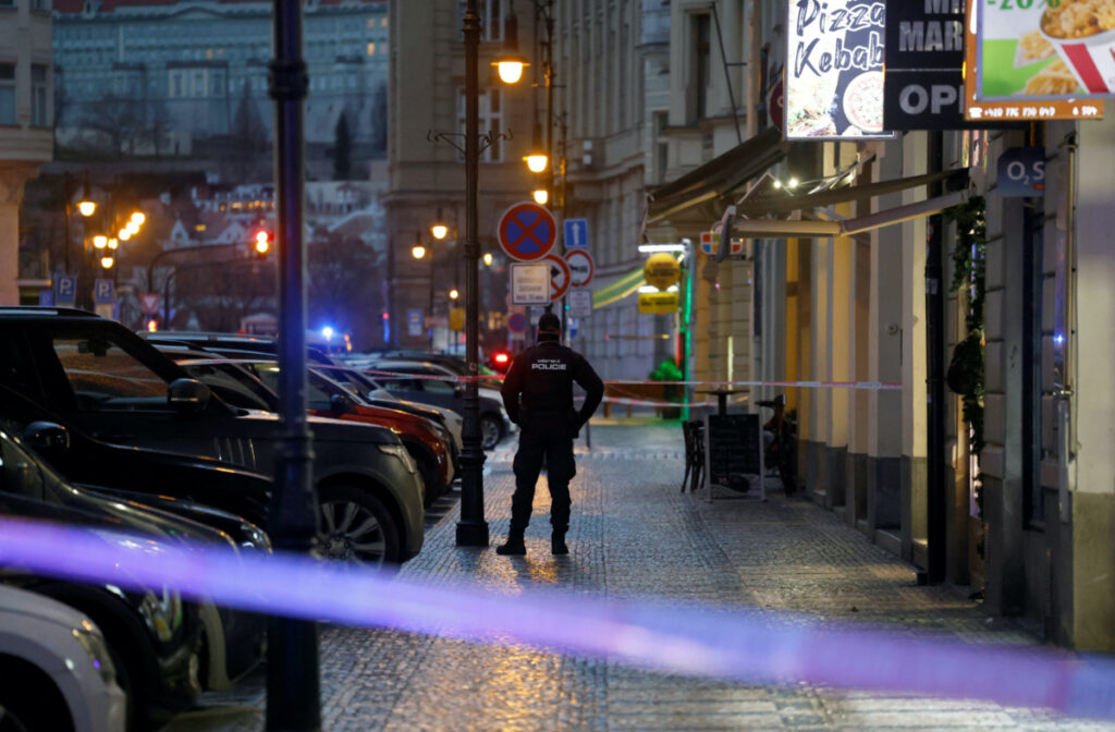 A police officer secures the area following the shooting at one of the buildings of Charles University in Prague, Czech Republic, on 21st December, 2023.