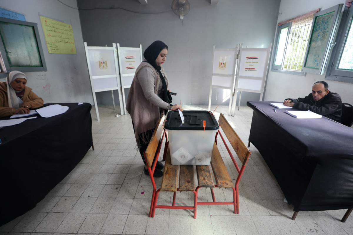 A woman casts her ballot at a polling station on the first day of the presidential election in Cairo, Egypt, on 10th December, 2023