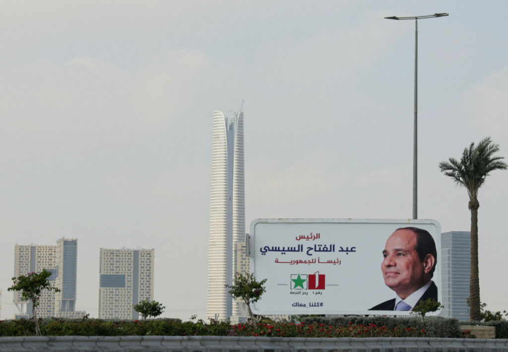 A banner of presidential candidate and current Egyptian President Abdel Fattah al-Sis stands next to the Central Business Districton 8th December, 2023
