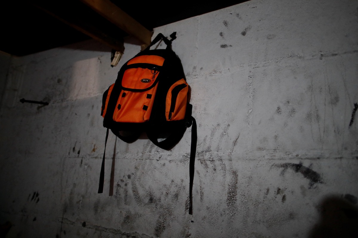 A schoolbag is hung in the self-built house of Camelia Toldea, 31, who lived in France since 2009, in a squatted warehouse that is threatened with imminent eviction ahead of the Paris 2024 Olympic games in Ile-Saint-Denis, near Paris, France, on 7th December, 2023