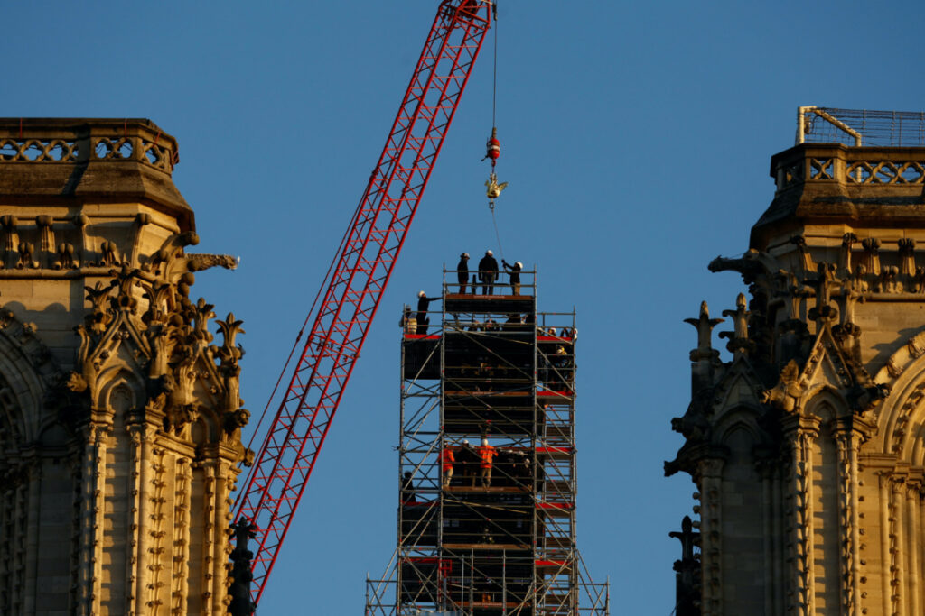 A crane raises the new rooster to install it at the top of the spire of the Notre-Dame de Paris Cathedral, which was ravaged by a fire in 2019 that sent its spire crumbling down, as restoration works continue in Paris, France, on 16th December, 2023