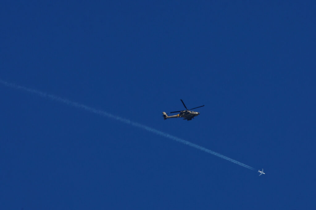 An Israeli military jet and an AH-64 Apache helicopter fly as strikes continue in Gaza, amid the ongoing conflict between Israel and the Palestinian Islamist group Hamas, as seen from Israel, on 11th December, 2023.