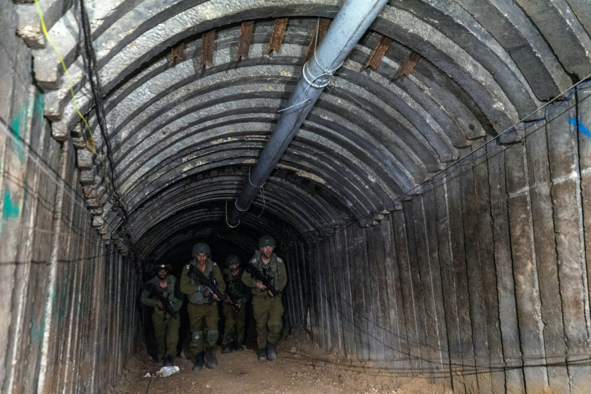 Israeli soldiers walk through what Israel's military says is an iron-girded tunnel designed by Hamas to disgorge carloads of Palestinian fighters for a surprise storming of the border, amid the Israeli army's ongoing ground operation against Palestinian Islamist group Hamas, close to Erez crossing in the northern Gaza Strip, on 15th December, 2023