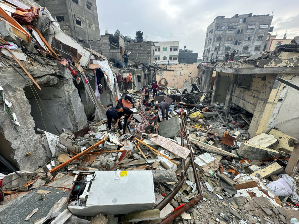 Palestinians inspect the site of Israeli strikes on houses, amid the ongoing conflict between Israel and the Palestinian Islamist group Hamas, in Rafah, in the southern Gaza Strip on 13th December 13, 2023.