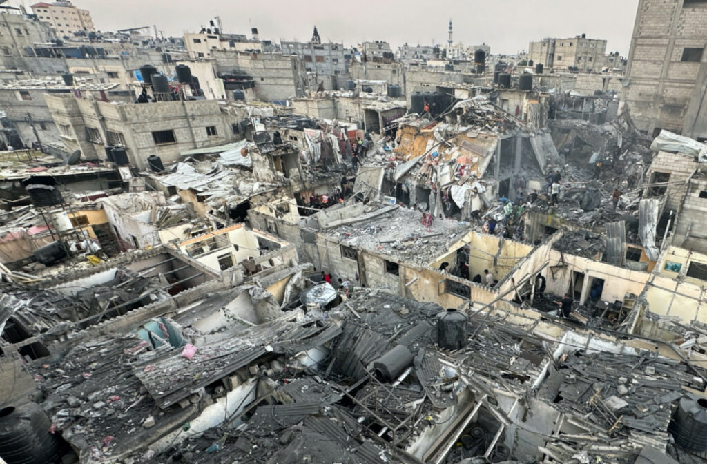People search through the rubble of damaged buildings following an Israeli air strike on Palestinian houses, amid the ongoing conflict between Israel and the Palestinian Islamist group Hamas, in Rafah in the southern Gaza Strip on 12th December, 2023.