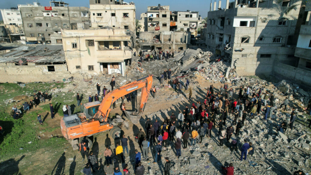 Palestinians gather at the site of an Israeli strike on a house, as the conflict between Israel and the Palestinian Islamist group Hamas continues, in Rafah in the southern Gaza Strip on 19th December, 2023