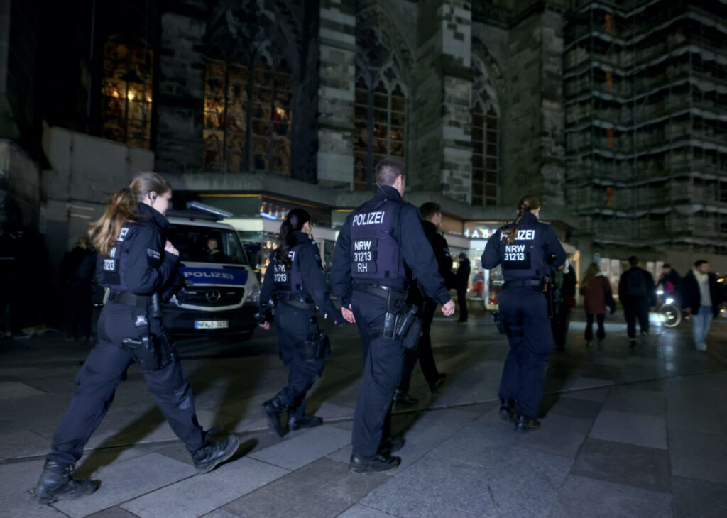 German police walk in front of the cathedral in central Cologne, Germany, on 23rd December, 2023.