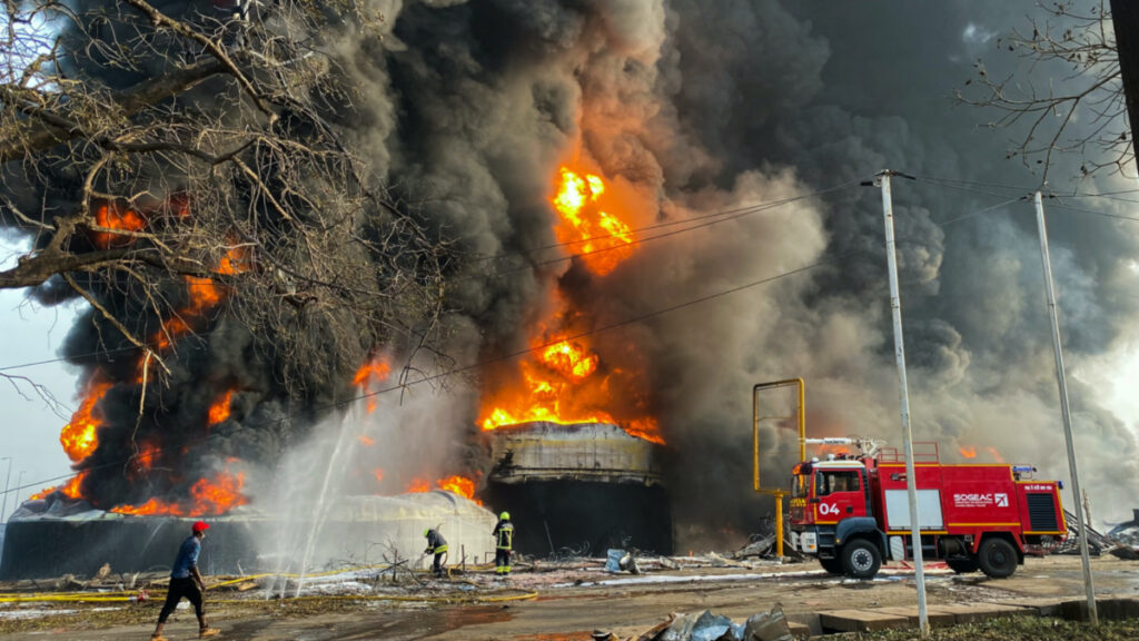 Firemen work to extinguish fire after a blast at an oil terminal in Conakry, Guinea on 18th December, 2023.