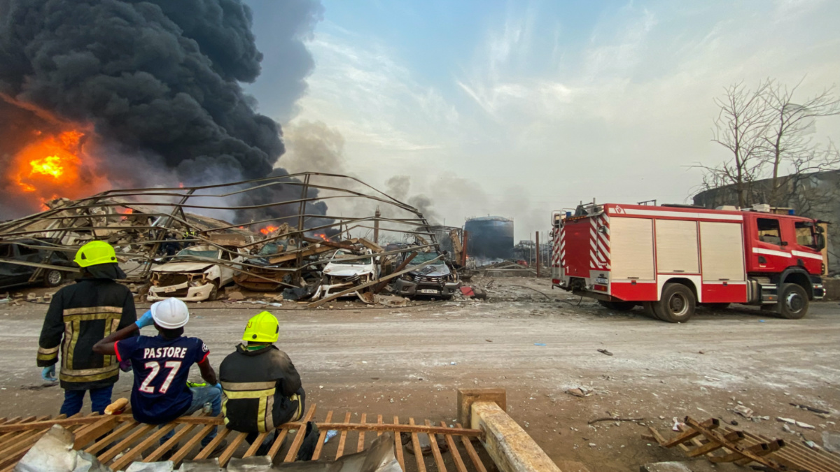 Firemen monitor the fire after a blast at an oil terminal in Conakry, Guinea on 18th December, 2023. 
