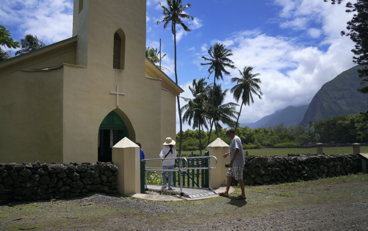 Kyong Son Toyofuku, left, her niece Yunra Huh, center, and husband, Lance Toyofuku, right, walk into St. Philomena Church during a tour of Kalaupapa, Hawaii, on Tuesday, on 18th July, 2023.