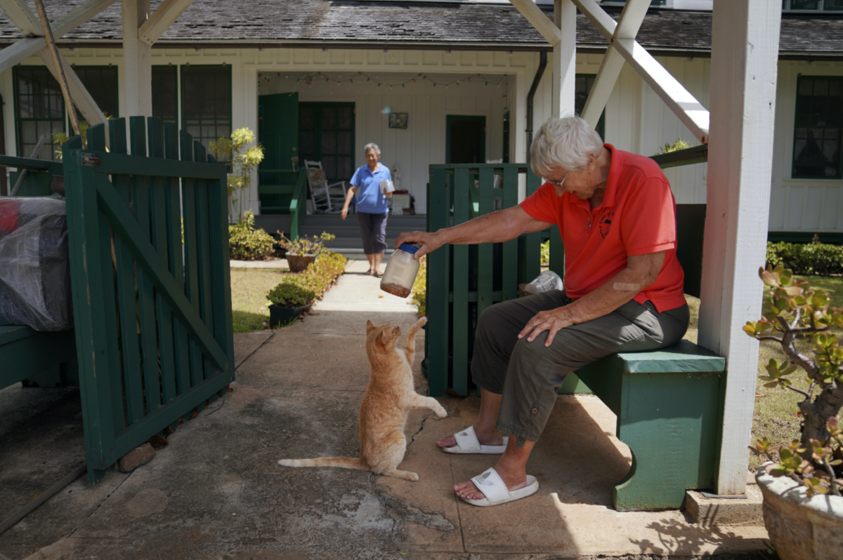 Barbara Jean Wajda of the Sisters of St Francis of the Neumann Communities holds a jar of treats for a cat on the peninsula of Kalaupapa, Hawaii, on Tuesday, 18th July, 2023