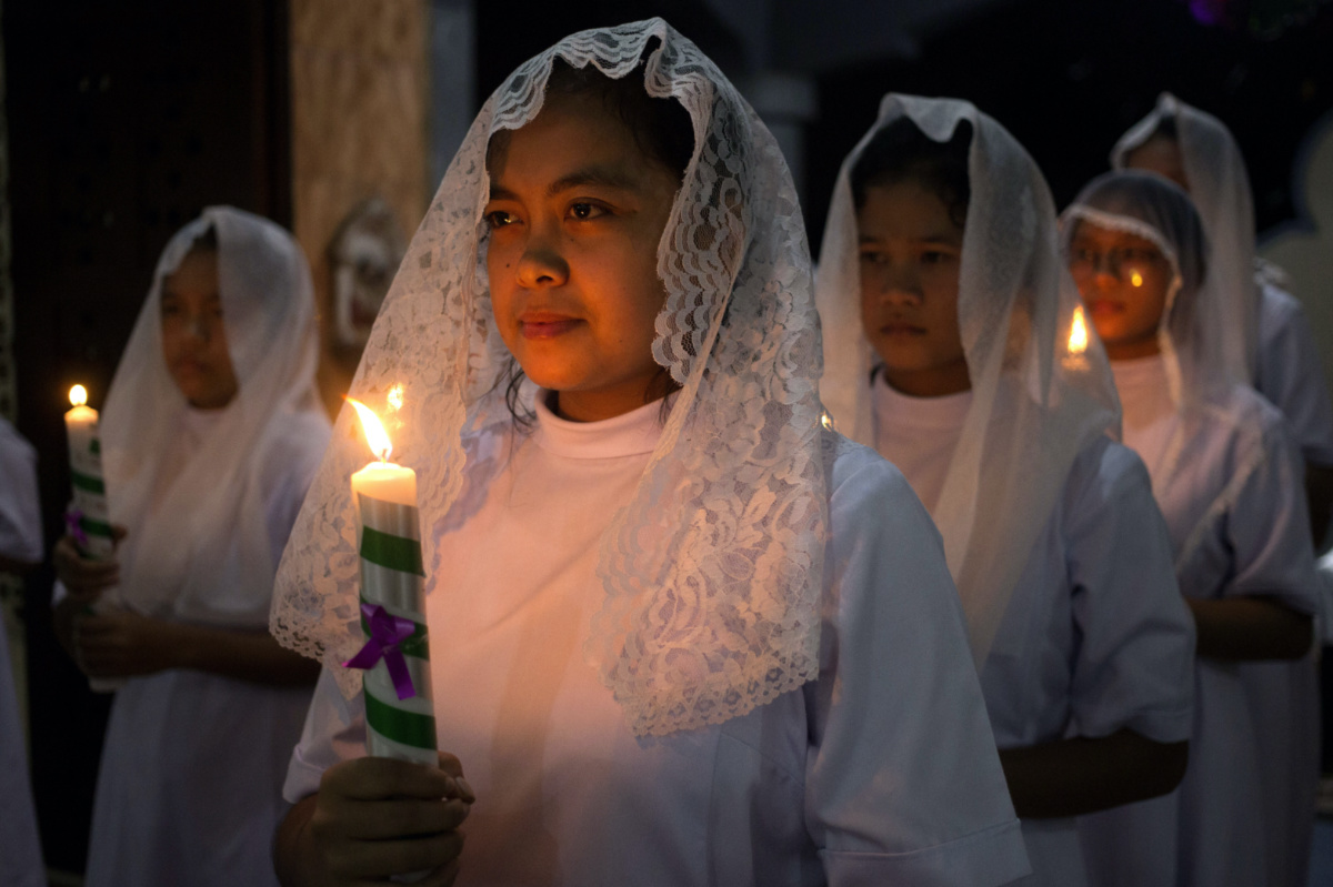 Nuns hold candles during the Christmas Eve mass at Graha Maria Annai Velangkanni Church in Medan, North Sumatra, Indonesia, on Sunday, 24th December, 2023