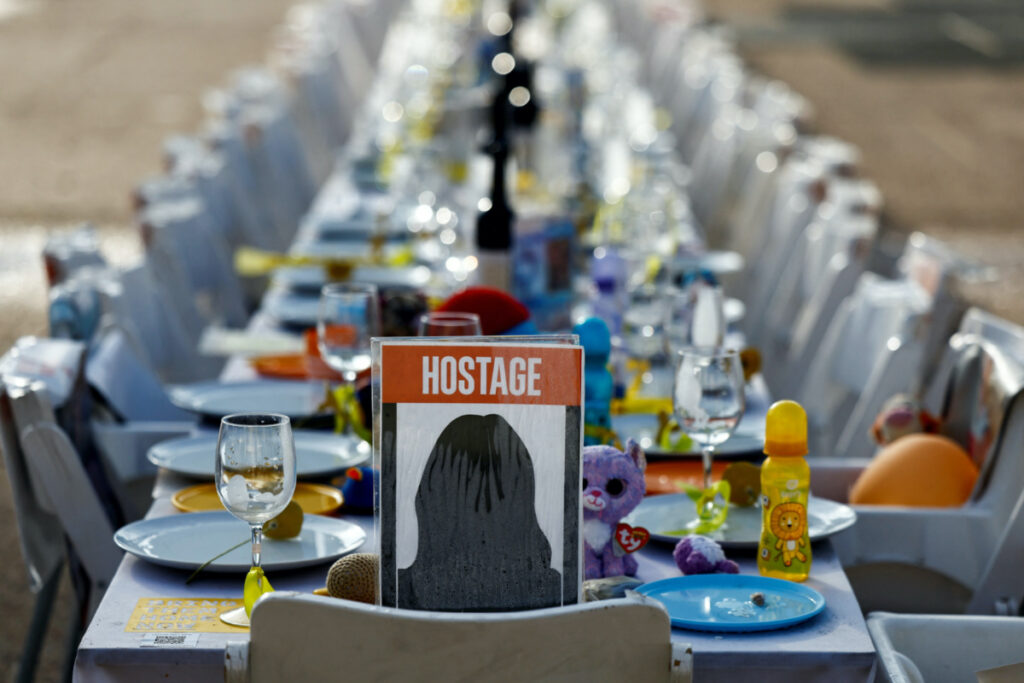 A dinner table is set with empty chairs that symbolically represent Israeli hostages, who are being held in the Gaza Strip after they were seized by Hamas gunmen on October 7, as the country observes the Jewish festival Hanukkah amid the ongoing conflict between Israel and the Palestinian Islamist group Hamas, in Tel Aviv, Israel on 7th December, 2023