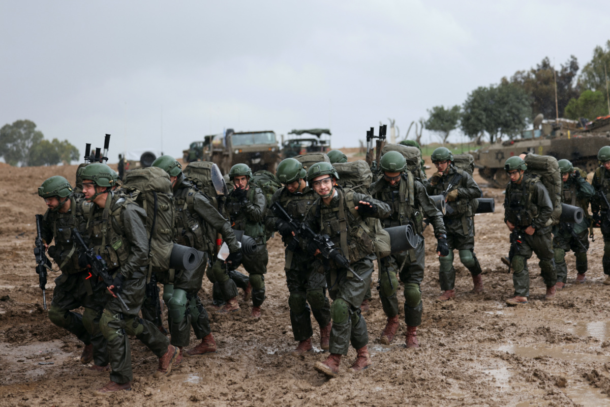 Israeli soldiers prepare to enter the Gaza Strip, amid the ongoing conflict between Israel and the Palestinian Islamist group Hamas, at Israel's border with Gaza in southern Israel, on 13th December, 2023.