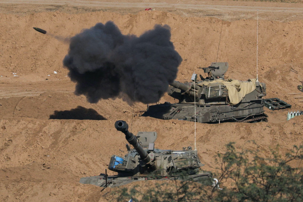 An Israeli self-propelled artillery unit fires amid the ongoing conflict between Israel and the Palestinian Islamist group Hamas, as seen from southern Israel, on 26th December, 2023