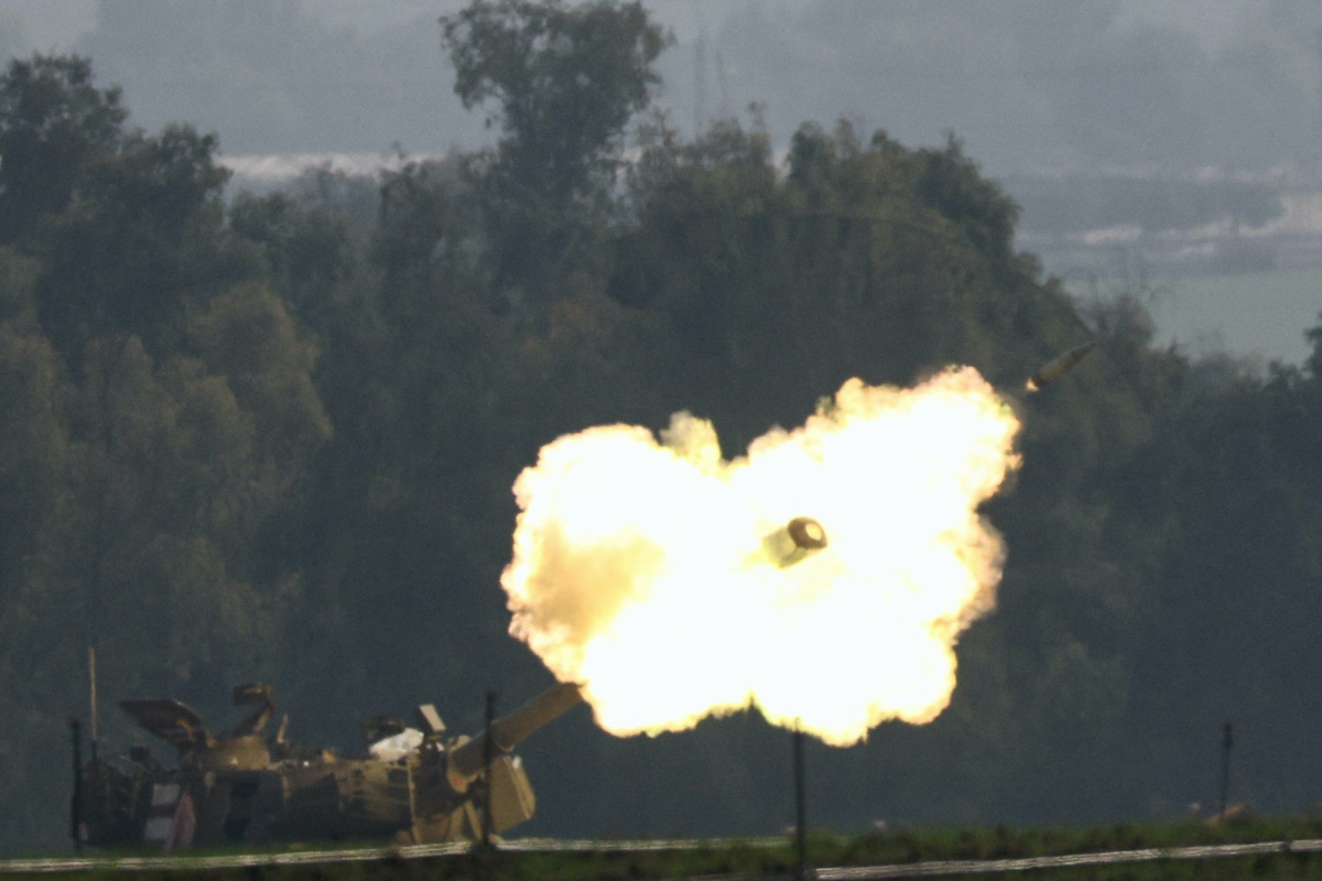 An Israeli artillery unit fires, amid the ongoing conflict between Israel and the Palestinian Islamist group Hamas, near the Israel-Gaza border, in southern Israel, on 28th December, 2023