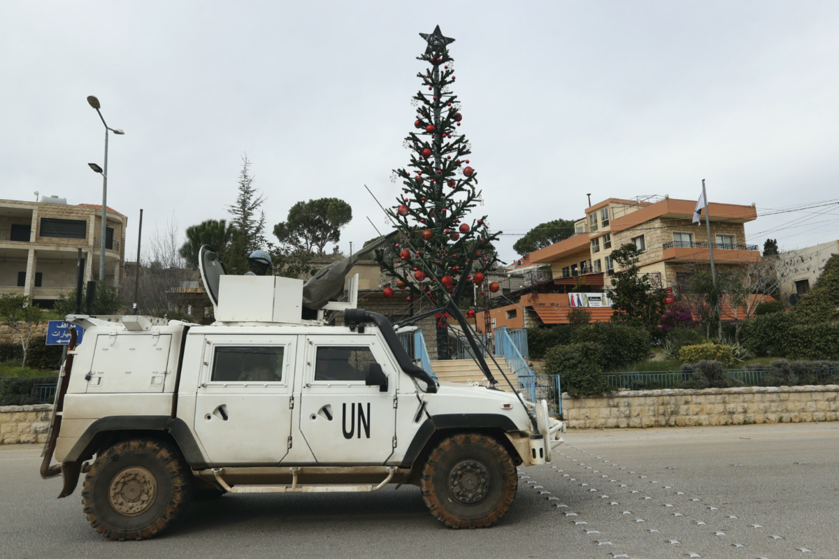 A UN peacekeeper vehicle passes next of a Christmas tree that set in Marjayoun square, a town near the Lebanese Israeli border, south Lebanon, on Thursday, 21st December, 2023.