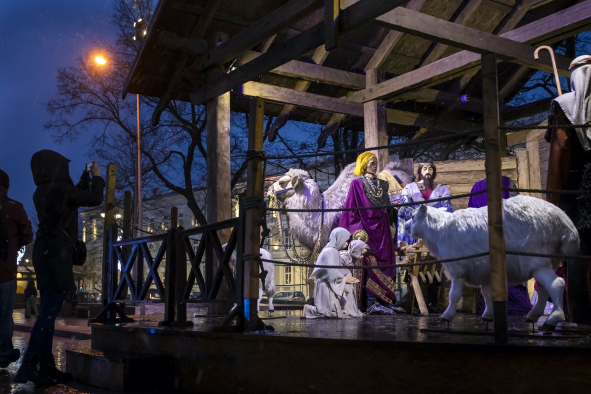 A woman photographs the Nativity scene installed for upcoming Christmas celebrations in Cathedral Square in Vilnius, Lithuania, on Saturday, 23rd December, 2023
