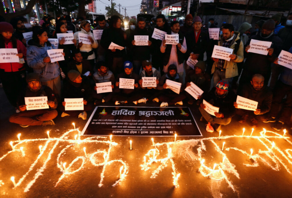 People hold placards as they take part in a condolence and protest meeting following the plane crash of a Yeti Airlines operated aircraft, in Pokhara on 15th January, 2023, in Kathmandu, Nepal, on 16th January, 2023