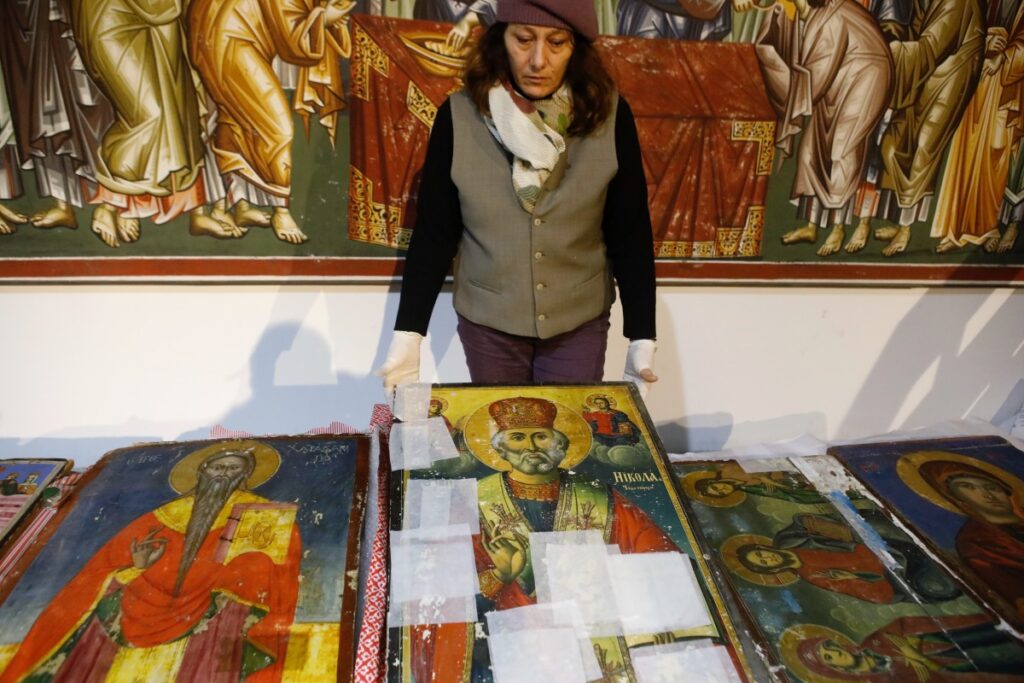A museum worker displays an icon returned from Albania at the National museum in Skopje, North Macedonia, late on Friday, 15th December, 2023