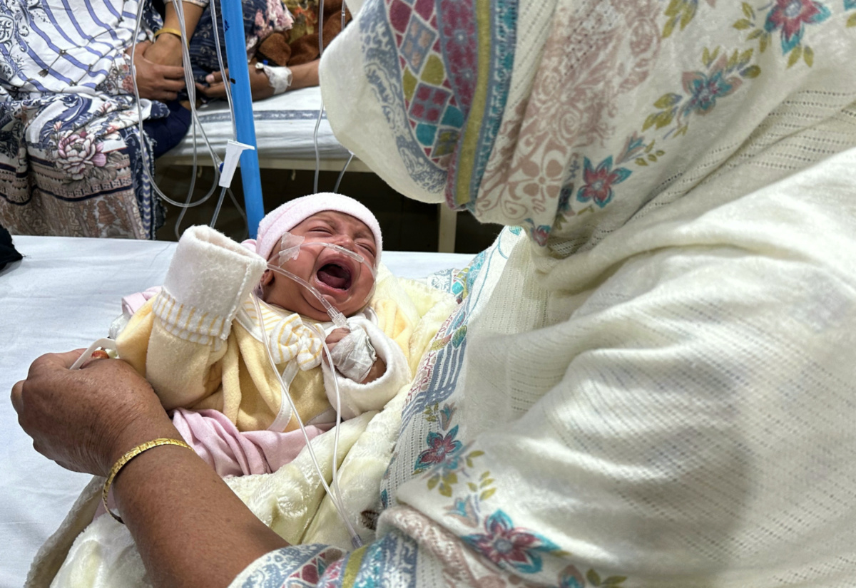 One-month-old baby girl, Noor cries while being comforted by her grandmother inside the paediatric ward at Sir Ganga Ram Hospital where she is being treated for pneumonia amidst soaring air pollution in Lahore, Pakistan, on 4th December, 2023.