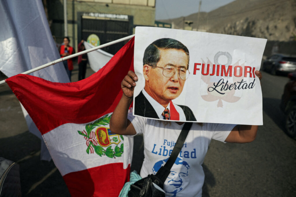 A follower of Peruvian President Alberto Fujimori holding a placard stands outside a prison, after a top court reinstated the pardon of Fujimori, in Lima, Peru, on 29th November, 2023