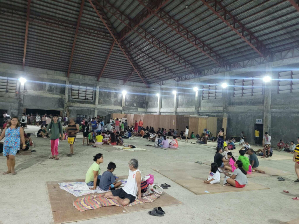 People gather at an evacuation centre, in the aftermath of an earthquake, in Hinatuan, Surigao del Sur, Philippines on 2nd December, 2023.