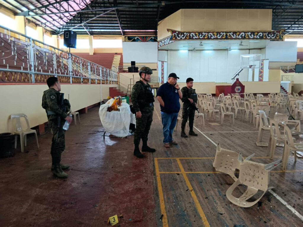 Lanao Del Sur Governor Mamintal Adiong Jrlooks on as law enforcement officers investigate the scene of an explosion that occurred during a Catholic Mass in a gymnasium at Mindanao State University in Marawi, Philippines, on 3rd December, 2023