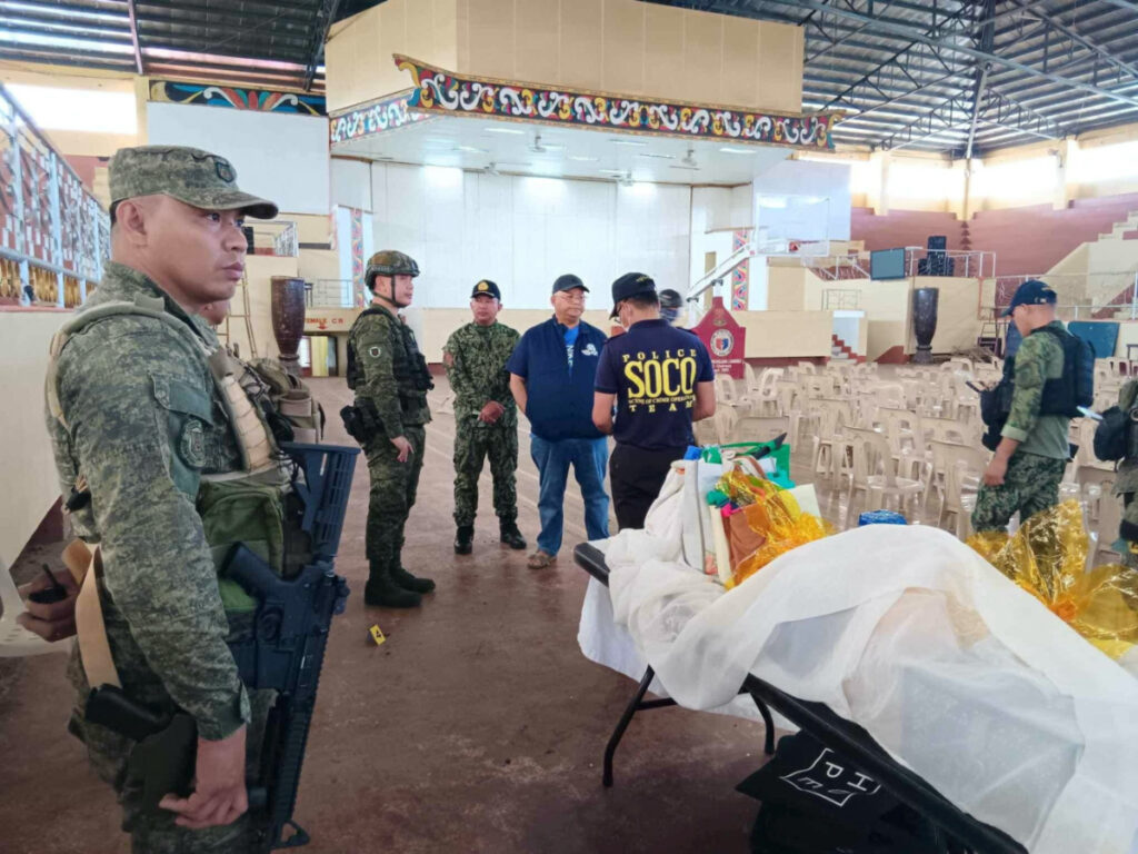 Lanao Del Sur Governor Mamintal Adiong Jr stands among law enforcement officers as they investigate the scene of an explosion that occurred during a Catholic Mass in a gymnasium at Mindanao State University in Marawi, Philippines, on 3rd December, 2023.